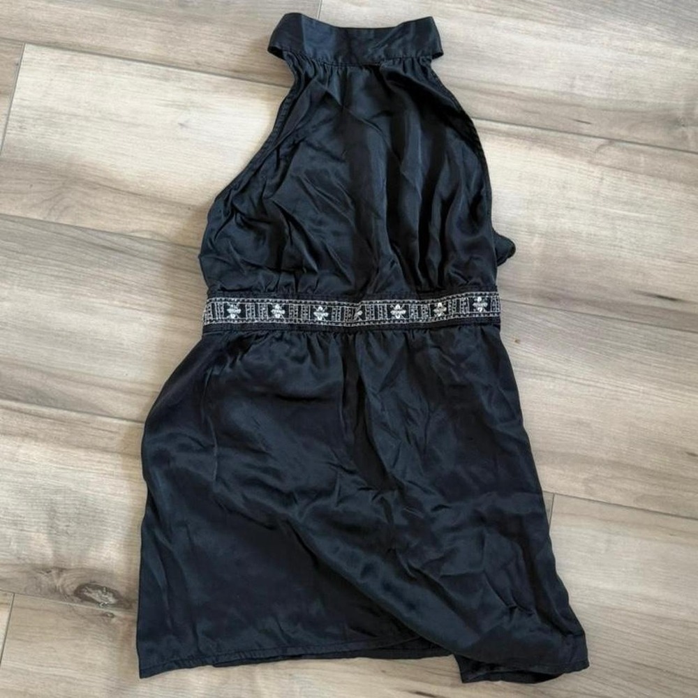 Black halter top with white floral embroidery along the waistband y2K style